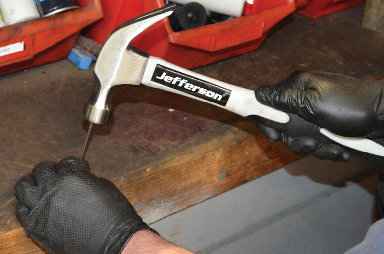 Jefferson Tools Fibreglass Handle Claw Hammer striking a nail